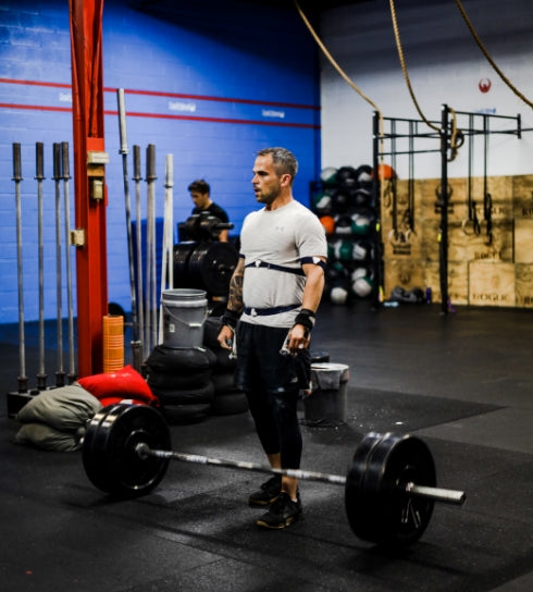 Standing over the bar with sensors on the arms